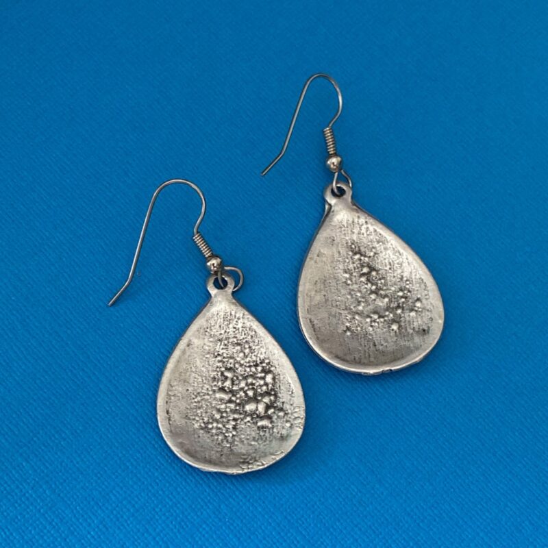 Back of earrings, showing solder spots