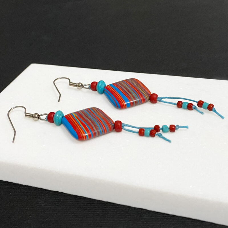 Red, blue and yelllow striped earrings on turquoise waxed cord.