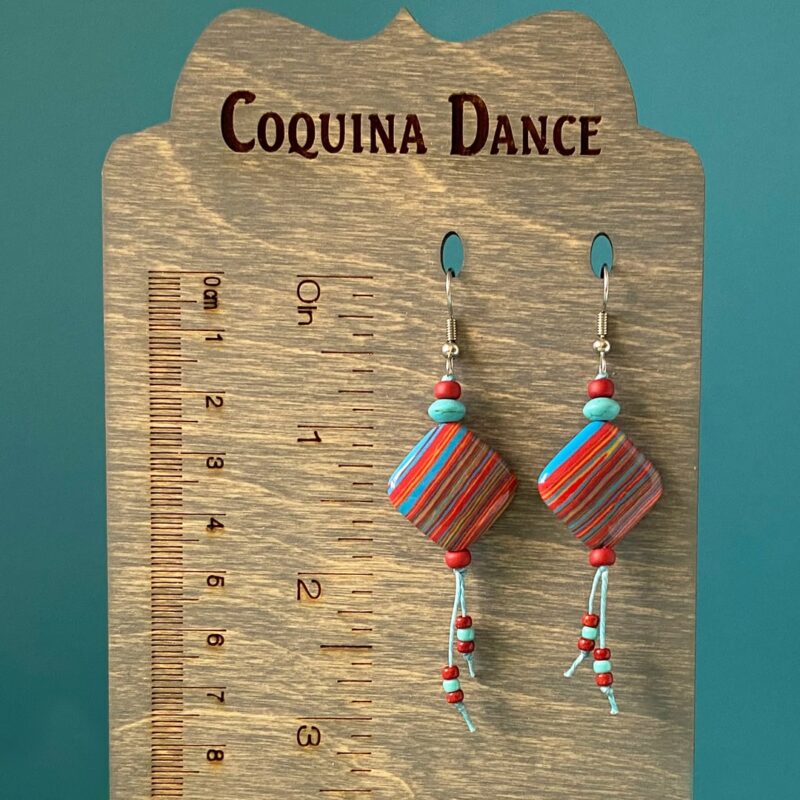 Red, blue and yelllow striped earrings on turquoise waxed cord.