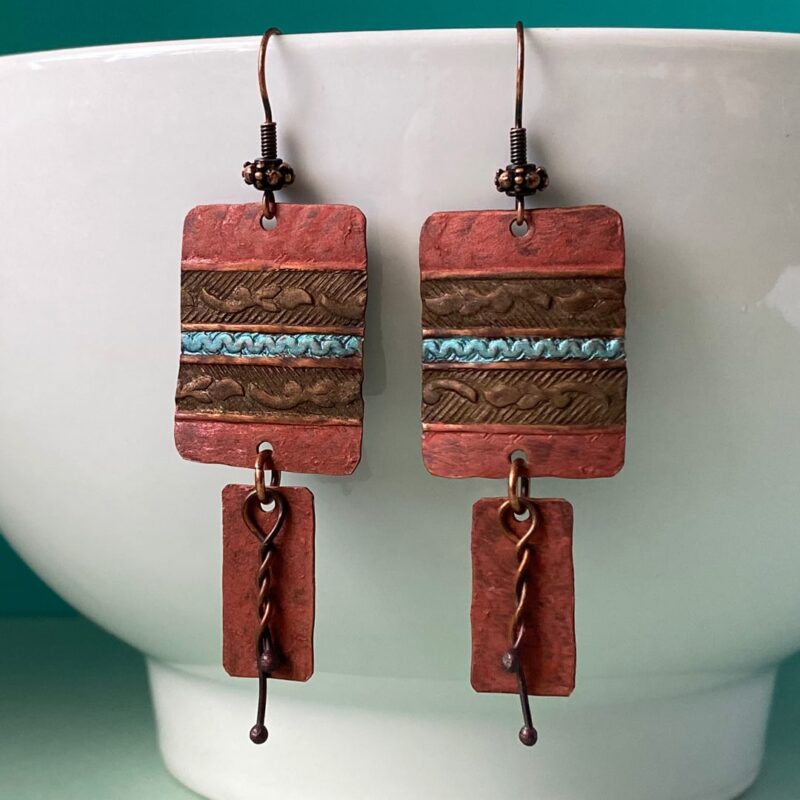 Textured copper components with a turquoise stripe in middle of earring