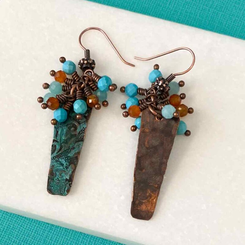 Copper patina embossed charms with orange and blue gemstones