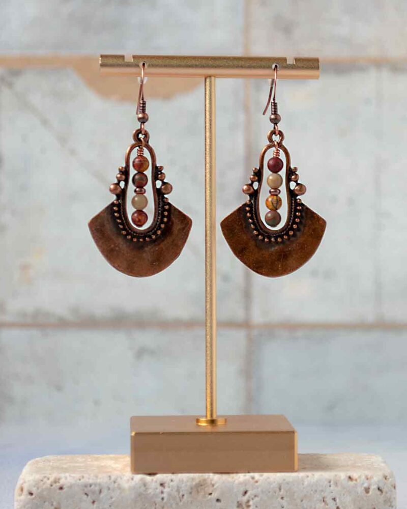 Earrings hanging from earring stand.