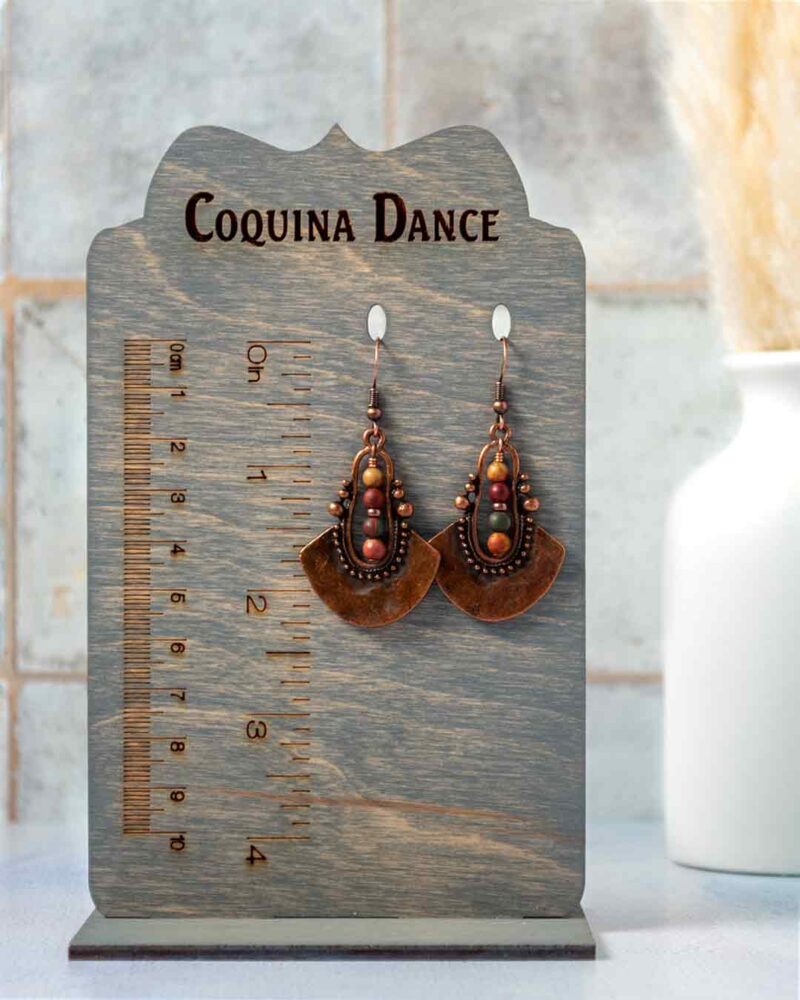 Earrings displayed on stand showing measurements.