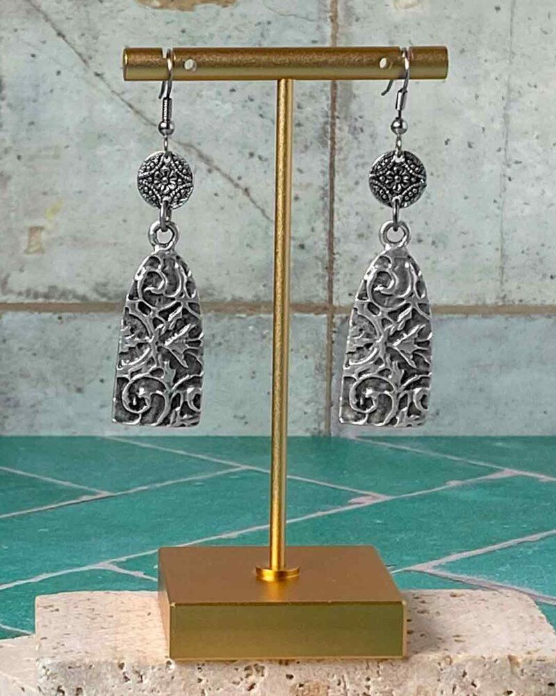 Earrings hanging from earring stand.