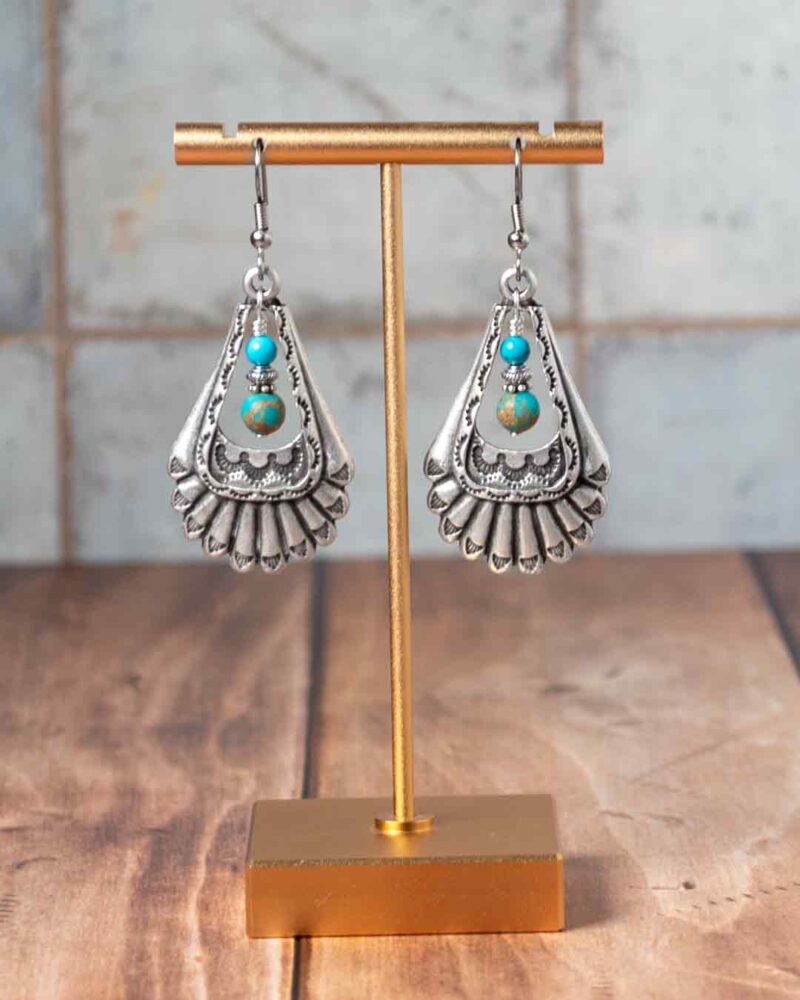 Earrings hanging from earring stand.