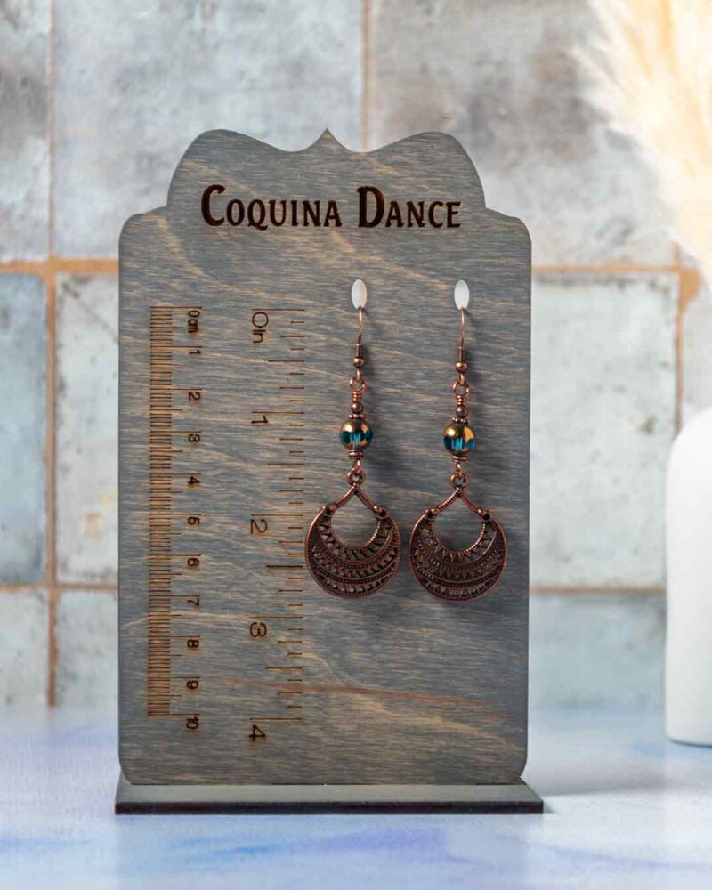 Earrings displayed on stand showing measurements.