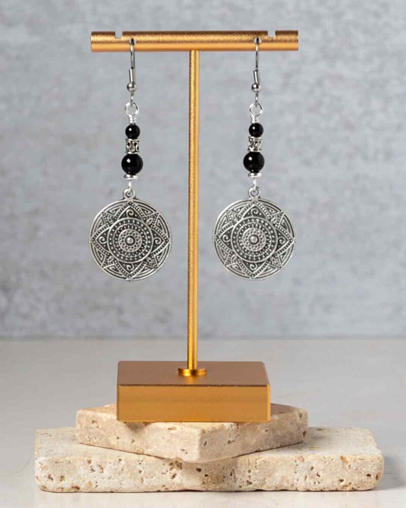 Earrings hanging from earring stand.