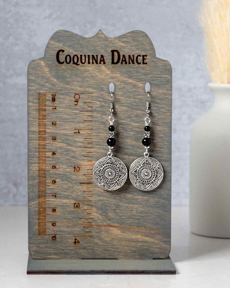 Earrings shown on stand showing measurements.