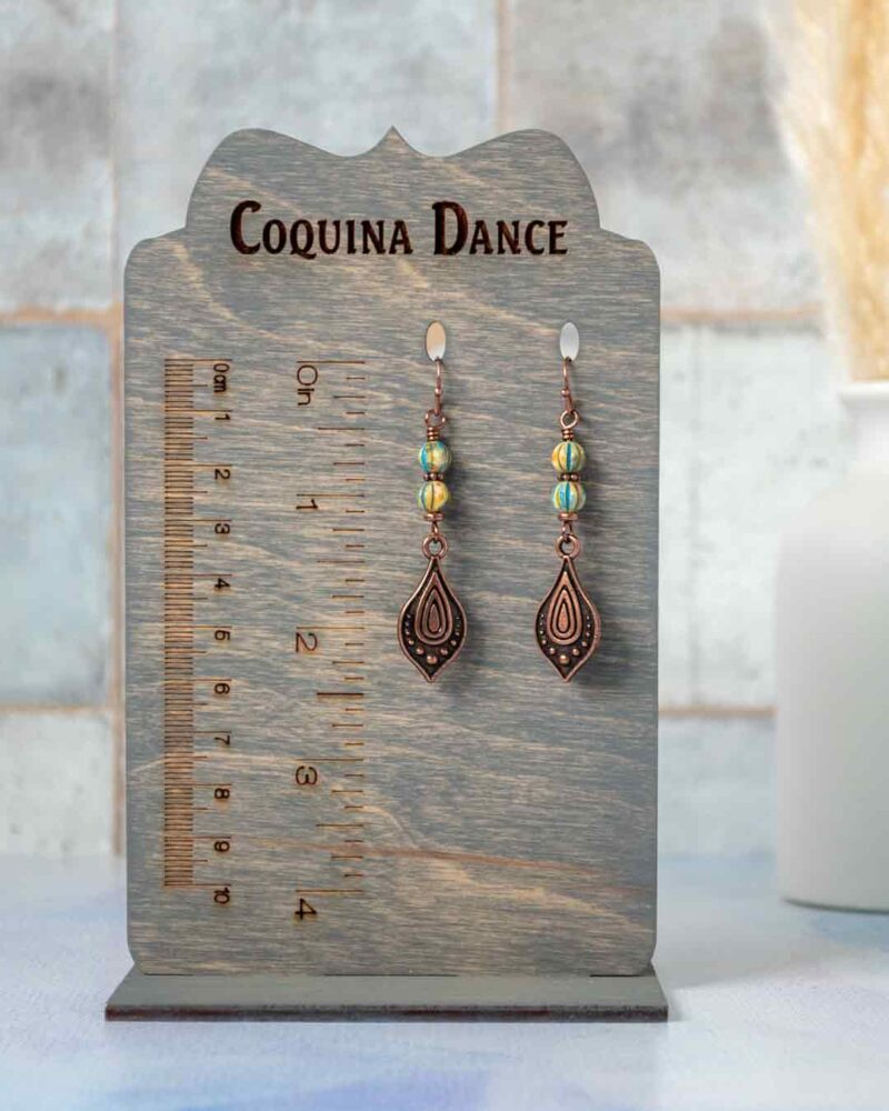 Earrings displayed on stand showing measurements.