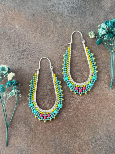 Turquoise Tango Beaded Hoop Earrings displayed flat with blue flowers on both sides