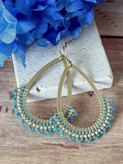 Beaded hoop earrings handwoven with blue and gold accents, handstitched by Coquina Dance Jewelry.